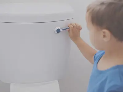 little boy flushing toilet